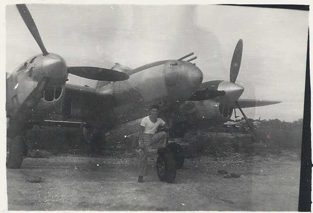 Dad standing in front of the airplanes he worked on.